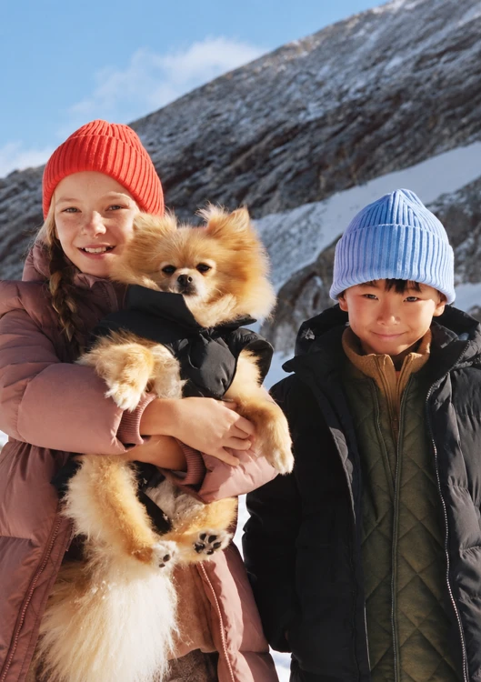 Original tightly cropped winter portrait of two children and a dog